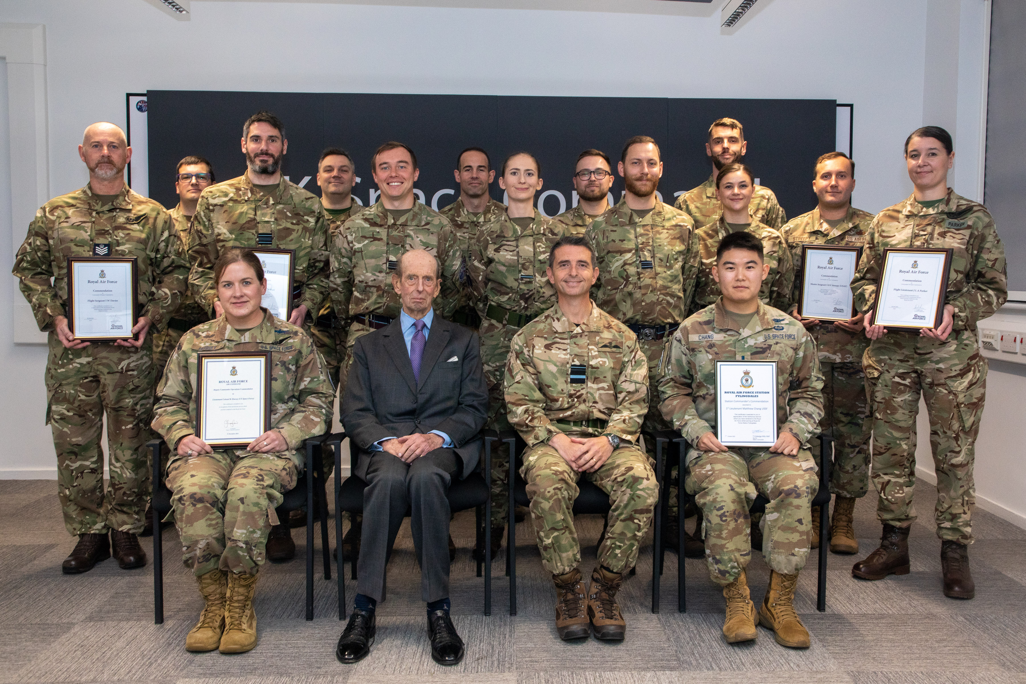 Image shows The Duke of Kent with RAF personnel holding certificates.